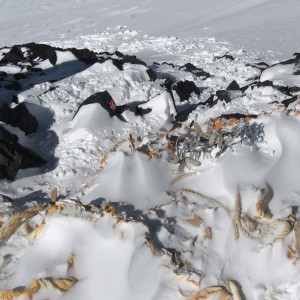 An old cache of crampons and supplies from an expedition decades ago