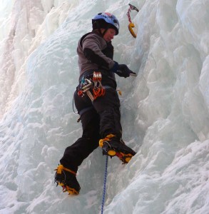 Woman ice climbing.