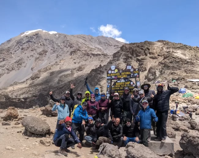 The team celebrates reaching Barafu Camp, the high camp on the Lemosho Route. That evening we would begin our summit push. how to climb mount kilimanjaro, how hard is mount kilimanjaro