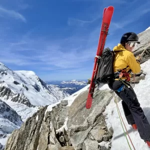 Rappelling into the Cosmiques Couloir with Mont Blanc in the background.
